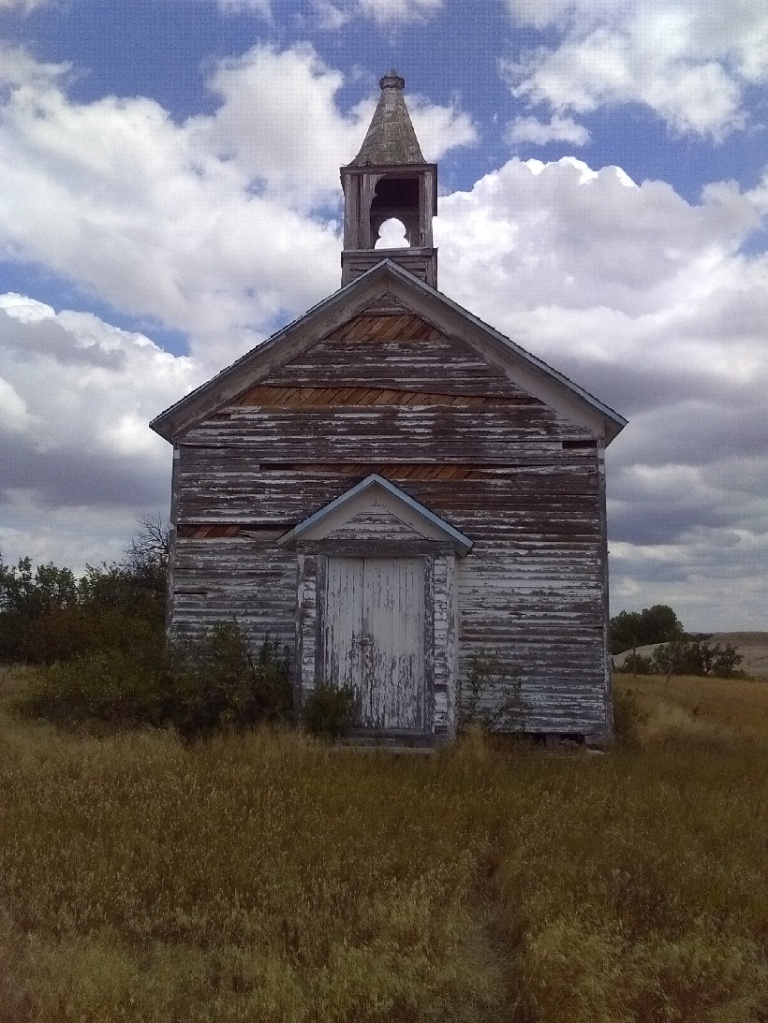 View of an old white church from the front. 